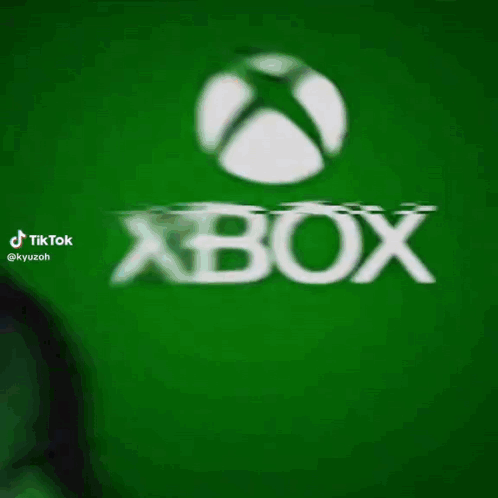 A Man In A Green Mask Is Standing In Front Of A Green Xbox Logo GIF
