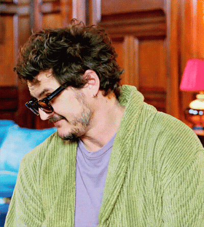 A Man In A Green Robe And Sunglasses Looks Down GIF