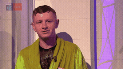 A Man In A Green Robe Is Standing In Front Of A Bbc Logo GIF