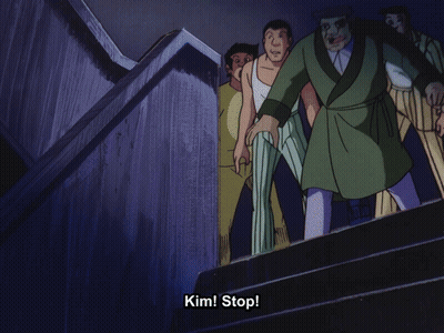 A Man In A Green Robe Is Walking Down Stairs With The Words Kim Stop Behind Him GIF