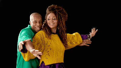 A Man In A Green Shirt And A Woman In A Yellow Sweater Are Posing For A Picture GIF