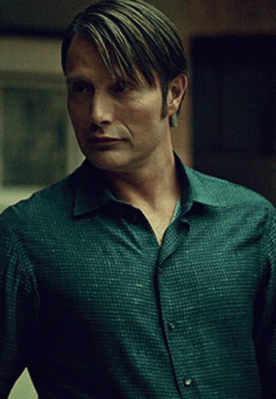 A Man In A Green Shirt Has A Very Serious Look On His Face GIF