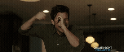 A Man In A Green Shirt Is Covering His Mouth With His Hands In A Game Night Ad GIF