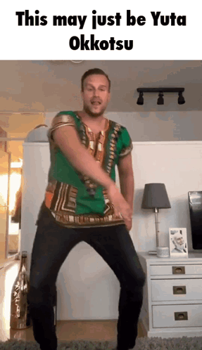 A Man In A Green Shirt Is Dancing In A Living Room With The Words This May Just Be Yuta Okkotsu Above Him GIF