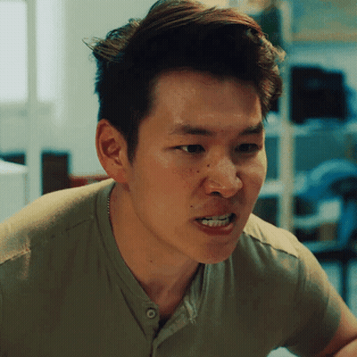 A Man In A Green Shirt Is Making A Face GIF