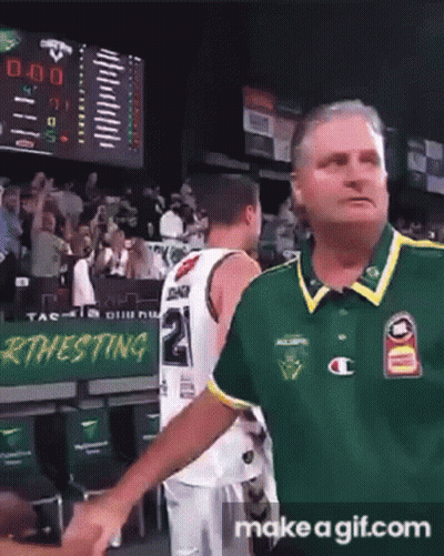 A Man In A Green Shirt Is Shaking Hands With A Basketball Player Wearing A Number 2 Jersey GIF