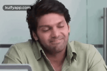 Man Smiling With Eyes Closed In Front Of Laptop GIF