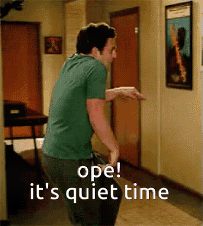 A Man In A Green Shirt Is Standing In A Hallway With The Words Ope It 'S Quiet Time Written On The Bottom GIF