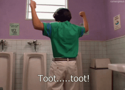 A Man In A Green Shirt Is Standing In A Public Restroom And Says Toot Toot GIF