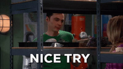 A Man In A Green Shirt Is Standing In Front Of A Shelf That Says " Nice Try " GIF