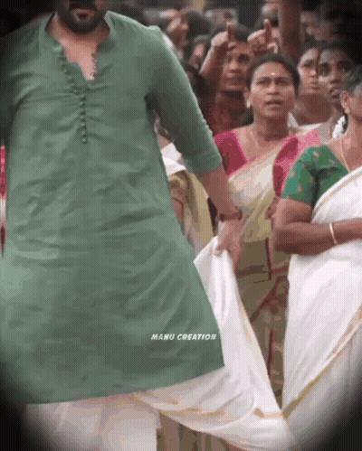 A Man In A Green Shirt With Manu Creation Written On The Bottom Of His Shirt GIF