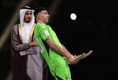 A Man In A Green Shirt With The Number 17 On It Holds A Trophy GIF