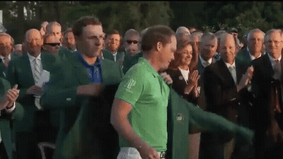 A Man In A Green Shirt With The Word Ap On It Stands In Front Of A Crowd Of People GIF