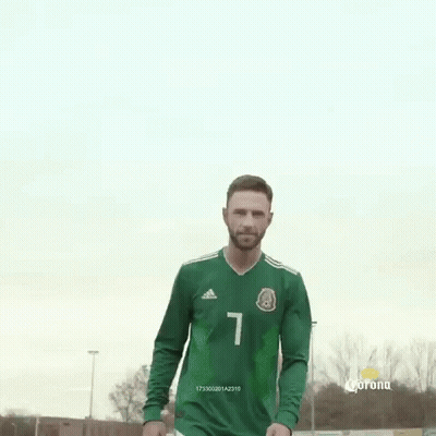 A Man In A Green Soccer Jersey With The Number 1 On It Is Standing On A Field . GIF