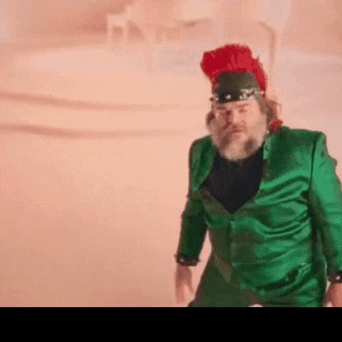 A Man In A Green Suit And Red Hat GIF