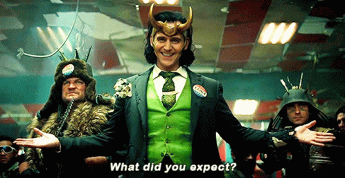 A Man In A Green Suit And Tie Is Standing In Front Of A Group Of Men And Says What Did You Expect . GIF