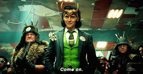 A Man In A Green Suit And Tie Is Standing In Front Of A Group Of People . GIF
