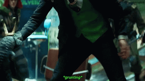 A Man In A Green Suit And Tie Is Standing Next To A Man In A Black Suit And Tie . GIF