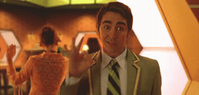 A Man In A Green Suit And Tie Is Waving At A Woman GIF
