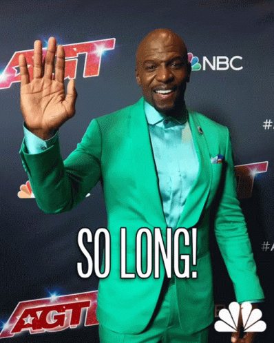 A Man In A Green Suit Is Standing In Front Of A Sign That Says Nbc GIF