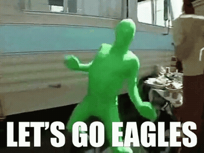 A Man In A Green Suit Says Let 'S Go Eagles In White Letters GIF