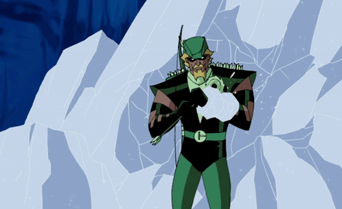 A Man In A Green Suit With The Letter G On His Chest Is Holding An Arrow GIF
