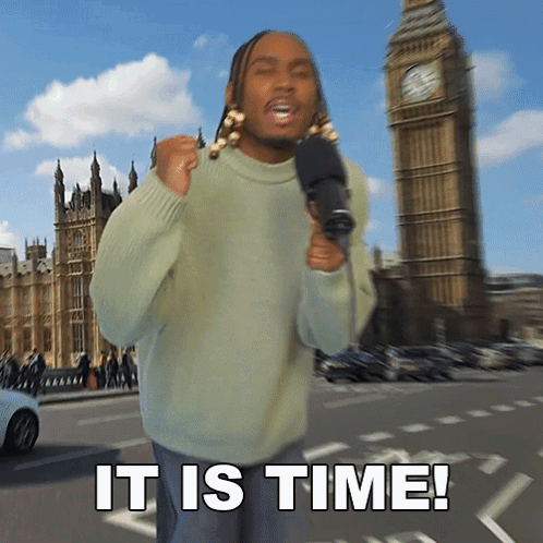 Man In Green Sweater Holds Microphone Near Big Ben GIF