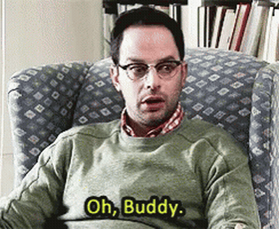 A Man In A Green Sweater Is Sitting In A Chair And Saying Oh Buddy GIF