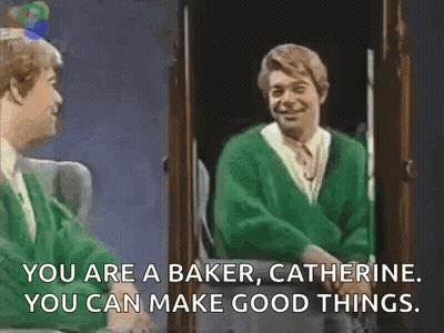 A Man In A Green Sweater Is Standing In Front Of A Mirror And Talking To Another Man . GIF