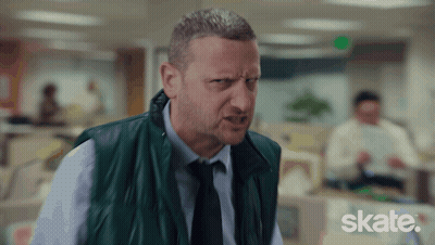 A Man In A Green Vest And Tie Is Making A Funny Face And The Word Skate Is Visible In The Corner GIF