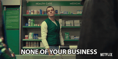 A Man In A Green Vest Is Standing In Front Of A Shelf That Says Health Care GIF