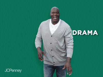 A Man In A Grey Cardigan Is Laughing In Front Of A Green Background With The Word Anxiety GIF