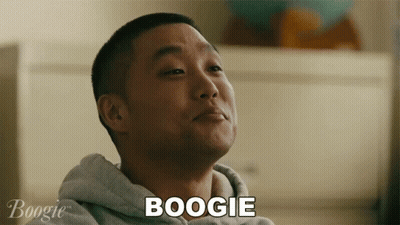 A Man In A Grey Hoodie Says Boogie In Front Of Him GIF