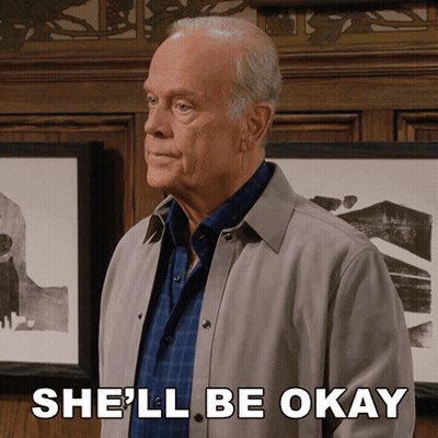 A Man In A Grey Jacket Says She 'Ll Be Okay In Front Of Framed Pictures GIF
