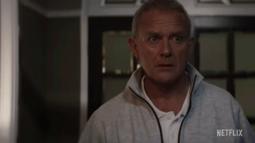 A Man In A Grey Jacket With Netflix Written On The Back GIF