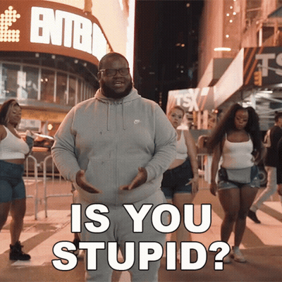A Man In A Grey Nike Sweatshirt Stands In Front Of A Sign That Says ' Entba ' GIF