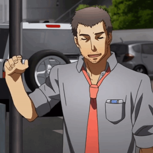 A Man In A Grey Shirt And Red Tie Stands In Front Of A Car GIF