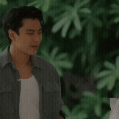 A Man In A Grey Shirt Is Praying With His Hands Folded GIF