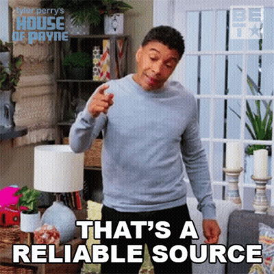 A Man In A Grey Sweater Is Pointing At The Camera And Saying That 'S A Reliable Source . GIF