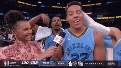 A Man In A Grizzlies Jersey Is Interviewed By A Reporter GIF