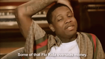 A Man In A Gucci Shirt Is Sitting In Front Of A Piano And Says Some Of That Flo Rida Overseas Money . GIF