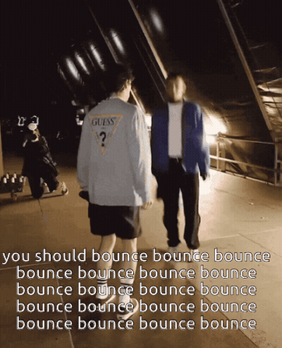 A Man In A Guess Shirt Walks With Another Man In A Blue Jacket GIF