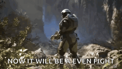A Man In A Halo Armor Is Holding A Blue Object In His Hand . GIF