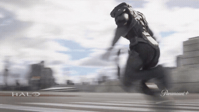 A Man In A Halo Costume Is Running On A Road GIF