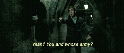 A Man In A Harry Potter Movie Is Standing In A Dark Hallway And Talking To Another Man . GIF
