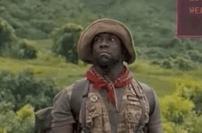A Man In A Hat And Bandana Is Standing In A Field With The Words `` I Hate This Game '' Written Above Him . GIF
