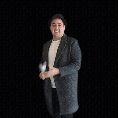 A Man In A Hat Holds A Piece Of Paper In Front Of A Sold Sign GIF