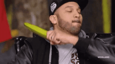 A Man In A Hat Is Being Punched In The Face By Another Man . GIF