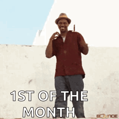 A Man In A Hat Is Dancing With The Words 1St Of The Month GIF