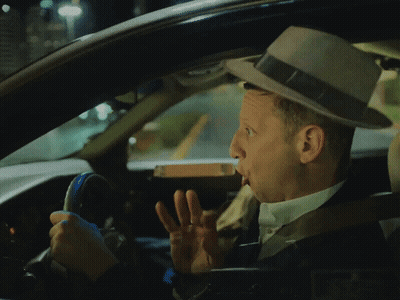 A Man In A Hat Is Driving A Car And Making A Funny Face GIF